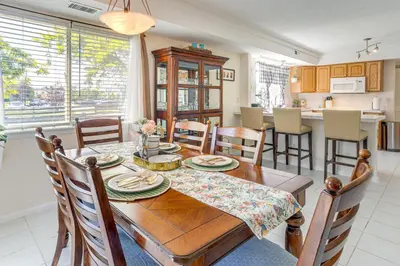 a kitchen and dining room with a wooden table and chairs at Pet-Friendly Retreat with Fenced Yard in Denver in Denver