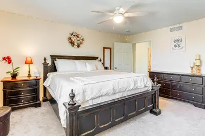 a bedroom with a large bed and two dressers at Pet-Friendly Retreat with Fenced Yard in Denver in Denver