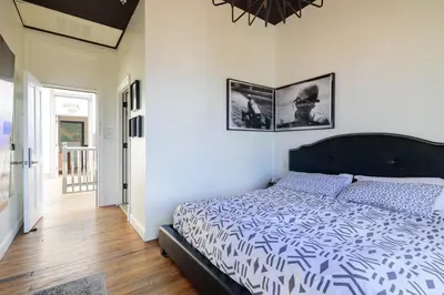 a bedroom with a bed with a blue and white comforter at Hostel Fish in Denver