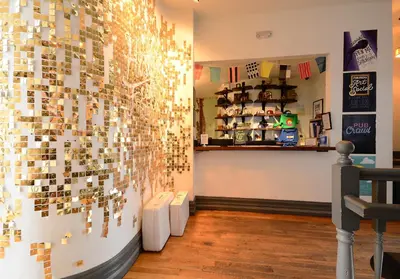 a room with a wall covered in many magnets at Hostel Fish in Denver