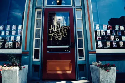 a red door of a building with writing on it at Hostel Fish in Denver