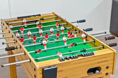 a large wooden table with snooker equipments at The Gather House Stylish Stay w Room to Play in Westminster