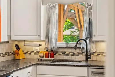 a kitchen with a sink and a window at The Gather House Stylish Stay w Room to Play in Westminster