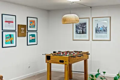 a room with a chess board on a table at The Gather House Stylish Stay w Room to Play in Westminster