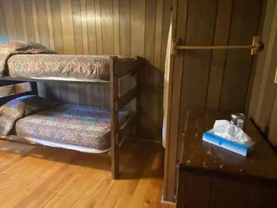 a room with two bunk beds and a table at Shadowcliff Rempel Lodge in Grand Lake