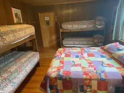 a room with three bunk beds in a room at Shadowcliff Rempel Lodge in Grand Lake