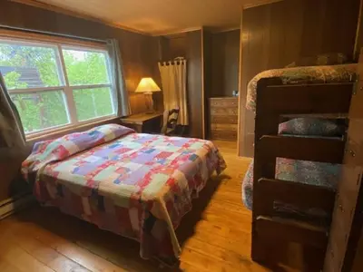 a bedroom with a bed and a window at Shadowcliff Rempel Lodge in Grand Lake