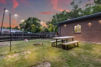 a picnic table and benches in a yard at 4BD Near DT | Hot Tub, Pingpong & Backyard Fun in Arvada