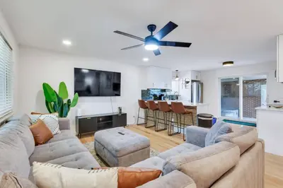 a living room with a couch and a ceiling fan at 4BD Near DT | Hot Tub, Pingpong & Backyard Fun in Arvada