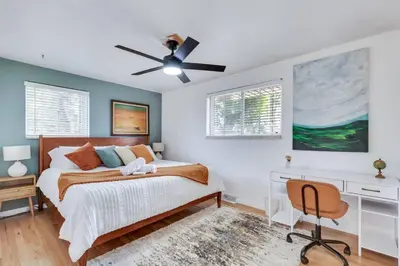 a bedroom with a bed and a ceiling fan at 4BD Near DT | Hot Tub, Pingpong & Backyard Fun in Arvada