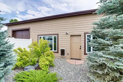 a house with a garage and trees in front of it at Private Hot Tub and Game Room Keenesburg Getaway! in Hudson
