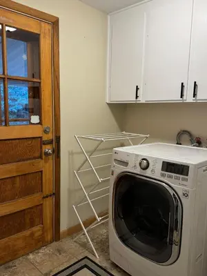 a washing machine in a kitchen with a door at Crown Hill Gem - Hot Tub, Yard, Parking in Lakewood