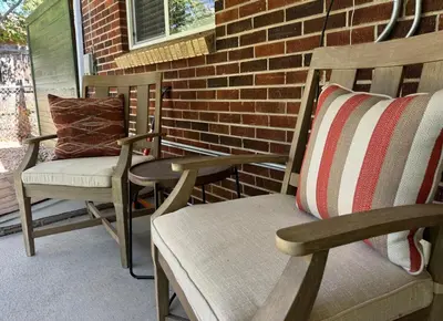 two rocking chairs and a pillow on a porch at Crown Hill Gem - Hot Tub, Yard, Parking in Lakewood