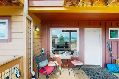 a patio with a table and chairs on a porch at View House in Fraser