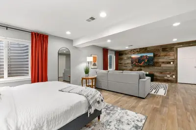 a bedroom with a bed and a couch at The Cycle Haus Rooftop Deck with Hot Tub and Views in Fort Collins