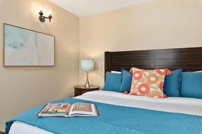 a bedroom with a bed with a book on it at Royal Perch - Chic Old Town Loft with King Suite in Fort Collins