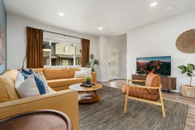 a living room with a couch and a table at Mosaic Modern - Dog Friendly, Pool and King Suite in Fort Collins