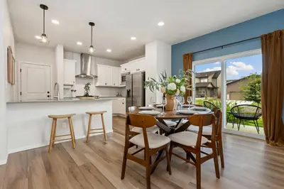 a kitchen and dining room with a table and chairs at Mosaic Modern - Dog Friendly, Pool and King Suite in Fort Collins