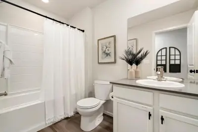 a white bathroom with a toilet and a sink at Mosaic Modern - Dog Friendly, Pool and King Suite in Fort Collins