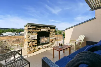 a living room with a fireplace on a patio at Elegant Mountain Haven - King Bed and Fireplaces in Fort Collins