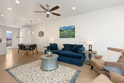 a living room with a blue couch and a table at Elegant Mountain Haven - King Bed and Fireplaces in Fort Collins