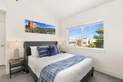 a bedroom with a bed and a window at Elegant Mountain Haven - King Bed and Fireplaces in Fort Collins