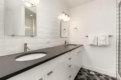 a bathroom with a sink and a mirror at Elegant Mountain Haven - King Bed and Fireplaces in Fort Collins
