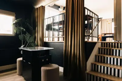 a room with a staircase with a desk and a stair case at House of Noir Elan Stunning 6BR Designer Retreat in Arvada