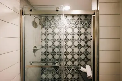 a shower with a glass door in a bathroom at House of Noir Elan Stunning 6BR Designer Retreat in Arvada