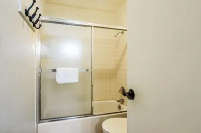 a bathroom with a shower with a toilet and a sink at Whisk Away to Winter Park 2 BDR 5 Min from Skiing in Winter Park