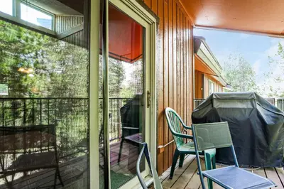a screened porch with chairs and a sliding glass door at Whisk Away to Winter Park 2 BDR 5 Min from Skiing in Winter Park