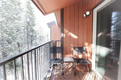a chair sitting on the balcony of a house at Whisk Away to Winter Park 2 BDR 5 Min from Skiing in Winter Park