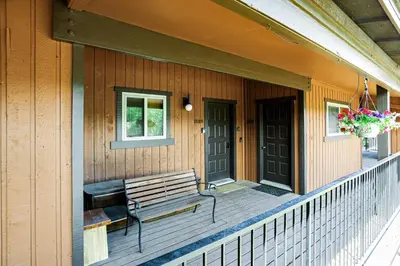 a bench on the porch of a house at Whisk Away to Winter Park 2 BDR 5 Min from Skiing in Winter Park