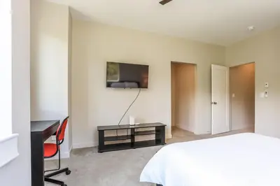 a bedroom with a bed and a desk and a tv at Granby Colorful Adventures - Breathtaking Views in Granby