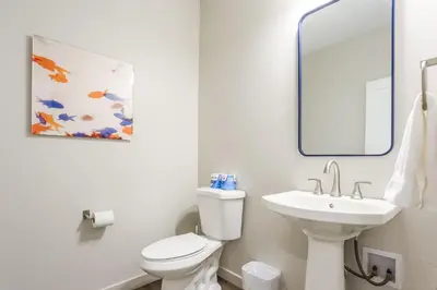 a bathroom with a white toilet and a sink at Granby Colorful Adventures - Breathtaking Views in Granby