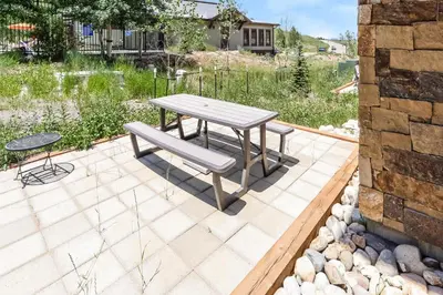 a picnic table and a bench on a patio at Granby Colorful Adventures - Breathtaking Views in Granby