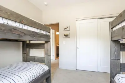 a bedroom with two bunk beds and a closet at Granby Colorful Adventures - Breathtaking Views in Granby
