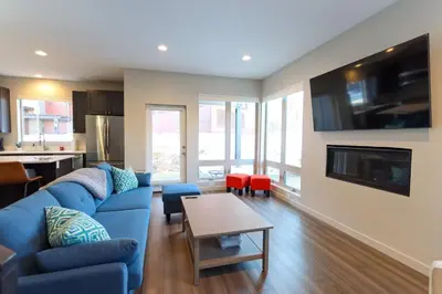 a living room with a blue couch and a table at Granby Colorful Adventures - Breathtaking Views in Granby