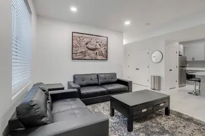 a living room with a couch and a table at 16 Mi to Dtwn Denver Modern Apt with Patio in Denver