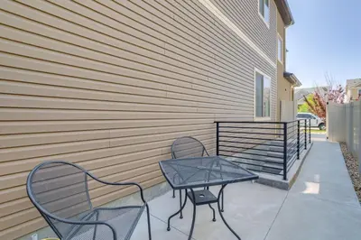 a patio with two chairs and a table next to a building at 16 Mi to Dtwn Denver Modern Apt with Patio in Denver