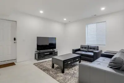 a living room with a couch and a tv at 16 Mi to Dtwn Denver Modern Apt with Patio in Denver