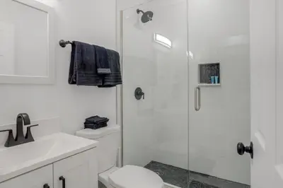a bathroom with a shower and a toilet and a sink at 16 Mi to Dtwn Denver Modern Apt with Patio in Denver