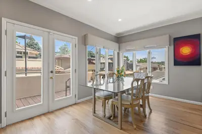 a dining room with a table and chairs and windows at Heart of Cherry Creek Group Retreat Hot Tub in Denver