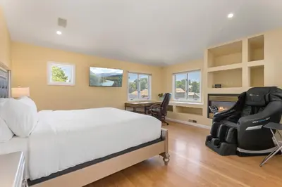 a bedroom with a bed and a desk and a chair at Heart of Cherry Creek Group Retreat Hot Tub in Denver