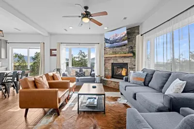 a living room with couches and a fireplace at 838B Wapiti Dr in Fraser