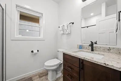 a white bathroom with a toilet and a sink at 838B Wapiti Dr in Fraser