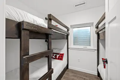 a bedroom with two bunk beds and a window at 838B Wapiti Dr in Fraser