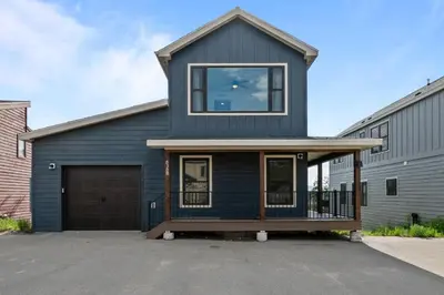 a blue house with a garage at 838B Wapiti Dr in Fraser