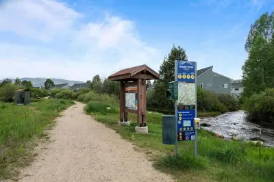 a sign on the side of a dirt road at 838B Wapiti Dr in Fraser