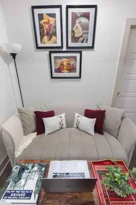 a living room with a couch and a table with a laptop at Chic Lower-Level Stay - Prime Walkable Locale in Denver